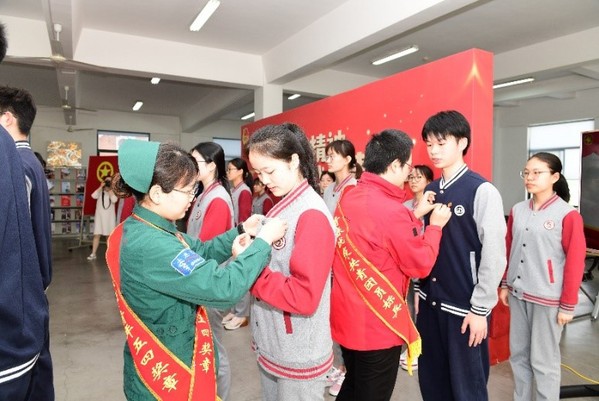 学校优秀毕业生代表、援鄂医疗队队员为团员代表佩戴团徽 学校优秀毕业生代表、援鄂医疗队队员为团员代表佩戴团徽